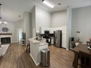 an empty kitchen and living room of a apartment at Mid City Condo in Huntsville