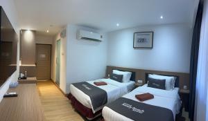 Postel nebo postele na pokoji v ubytování Pangkor Sandy Beach Resort