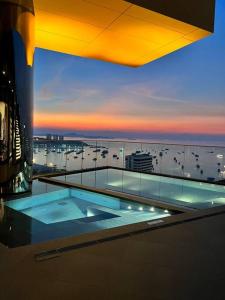 a swimming pool on top of a building at Secret Gem Sea-View King Size EDGE Central Pattaya in Pattaya Central