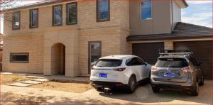two cars parked in front of a house at Newly built cozy double storey 3 bed room house at Prospect. in Prospect