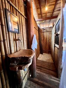 a bathroom with a sink in a log cabin at Coco Lodge, vista al mar in La Poza