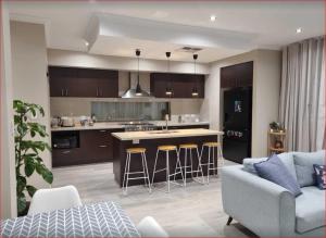 a kitchen and living room with a couch and a table at Newly built cozy double storey 3 bed room house at Prospect. in Prospect