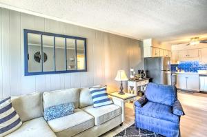 a living room with a couch and a chair at Myrtle Beach Condo with Balcony Walk to Beach! in Myrtle Beach