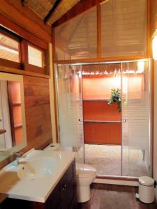 a bathroom with a shower and a toilet and a sink at Ten Moons Lipe Resort in Ko Lipe