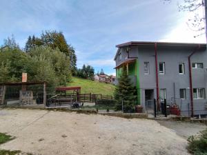 a house with a fence in front of it at Vila Cri Cri in Buşteni