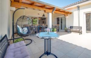 a patio with a bird cage and a swing at Amazing Home In Linardici With Wifi in Linardići