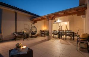 a large patio with a table and chairs on it at Amazing Home In Linardici With Wifi in Linardići