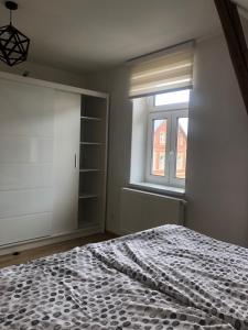 a bedroom with a bed and a window at Vila se zahradou a s parkováním v ceně in Jablonec nad Nisou