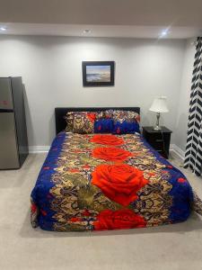 a bedroom with a bed with a colorful comforter at TREASURES HOME 5 in Brampton