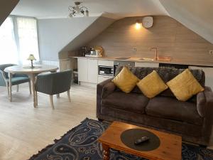 a living room with a couch and a table at Busby Apartments in Carmunnock