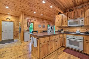 a kitchen with wooden cabinets and a counter top at Dog-Friendly Gaylord Retreat Less Than 8 Mi to Town! in Gaylord