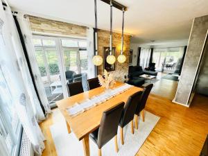 a dining room with a wooden table and chairs at Exclusive High-quality Apartment Spessart in Marktheidenfeld