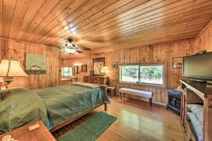 a bedroom with a bed and a television in a room at Family Home with Stunning River and Mountain View in Priest River