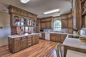 a large kitchen with wooden cabinets and wooden floors at Peaceful Bellevue Gem on Working Cattle Ranch in Bellevue
