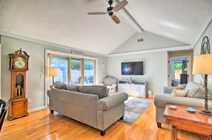 a living room with two couches and a clock at 2 Mi to South Cape Beach State Park Home with Yard! in Mashpee