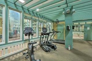 a gym with two exercise bikes in a room with windows at Walk to Ocean Condo with Community Perks on HHI in Hilton Head Island