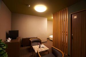 a hotel room with a desk and a bed at Meitoya So in Zao Onsen