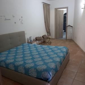 a bedroom with a bed with a blue comforter at Familyhouse Pevero Hill Porto Cervo in Porto Cervo