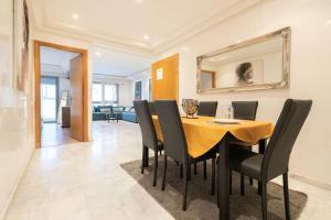 a dining room with a yellow table and black chairs at Racine Two bedroom flat near twin center in Casablanca