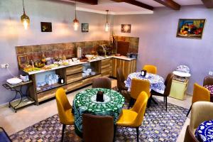 a restaurant with two tables and chairs and a counter at Hotel Gold Tower in Mestia