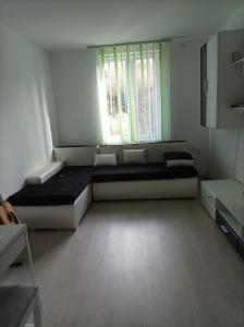 a bedroom with a large bed and a window at Apartament două camere in Uricani