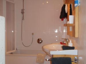 a bathroom with a sink and a shower and a tub at Apartment Gaby in Kitzbühel