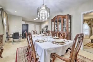 a dining room with a table and chairs and a chandelier at Bright Springfield Apartment with 2 Balconies! in Springfield