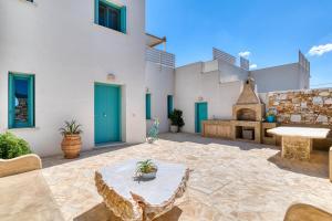 a patio with a table and a building at Pandesia Villas Private Pools in Mármara