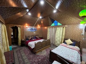 a bedroom with two beds in a room at New Silver Jubilee Heritage Group Of Houseboats in Srinagar