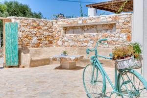 a blue bike parked in front of a stone building at Pandesia Villas Private Pools in Mármara