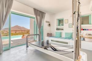 a bedroom with a bed and a large window at Pandesia Villas Private Pools in Mármara