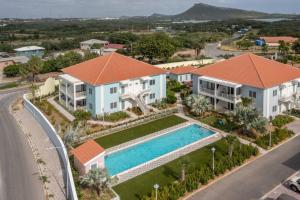 an aerial view of a house with a swimming pool at Penthouse Apartment next to Blue Bay Golf & Beach! in Willemstad