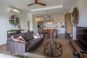 a living room with a couch and a table at Penthouse Apartment next to Blue Bay Golf & Beach! in Willemstad