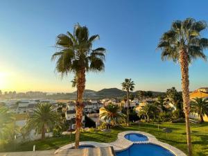 a resort with palm trees and a swimming pool at el toro in Finestrat