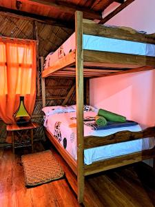 a bedroom with two bunk beds in a room at Hostal Olmito Canoa in Canoa