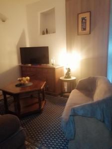 a living room with a bed and a table with a tv at Apartment Marsala Tita in Bar