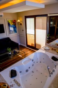 a large bath tub in a living room at Black Bird Thermal Hotel & SPA in Gokcedere