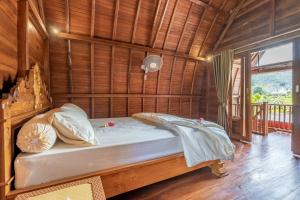 a bedroom with a bed in a wooden room at Pondok Carik Villa Manggis in Manggis