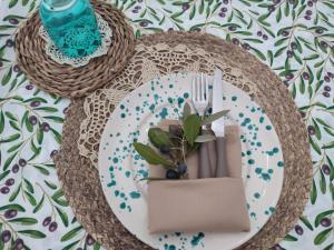 a table with a plate with a plant on it at Casedda Ostunese in Ostuni