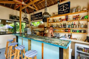 a man standing behind a bar in a restaurant at Camotes-Hidden-Huts in San Francisco