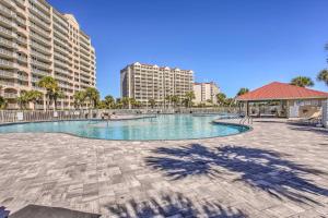 a large swimming pool with buildings in the background at Barefoot Landing Retreat with Resort Amenities! in Myrtle Beach