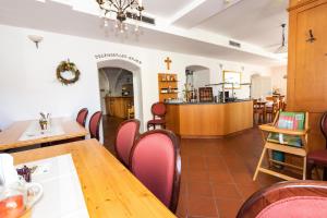 a dining room with tables and chairs and a cross on the wall at Schwarzacher Hof in Niederbayern in Schwarzach +18 photos