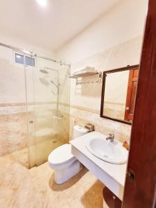 a bathroom with a toilet and a sink and a mirror at SeaSala Beach Hotel in Vung Tau