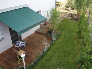 an overhead view of a deck with a blue awning at Apartment Renate Strohhöfer in Hirschaid