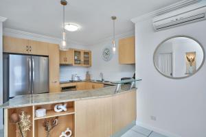 a kitchen with a counter and a mirror at Stunning 2-3 Bed Penthouse Glorious Ocean Views in Trinity Beach
