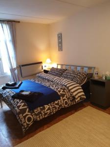 a bedroom with two beds and a table and a window at Saint Cyr du Bailleul - Maison in Saint-Cyr-du-Bailleul +9 photos