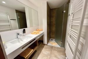 a bathroom with a sink and a mirror at Hotel Pachernighof in Velden am Wörthersee