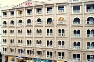 a large white building with a lot of windows at Comfortable & Lovely 1 Bed Apt In Bahria Town in Rawalpindi