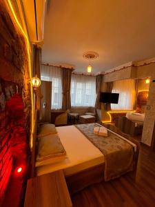 a bedroom with a bed and a living room at GOLDEN ARROW OLD CİTY HOTEL in Istanbul