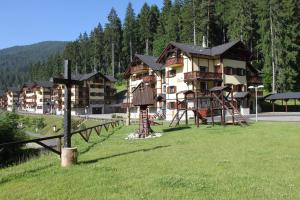 a large building with a playground in a field at Apartment Barbora 7 in Ružomberok